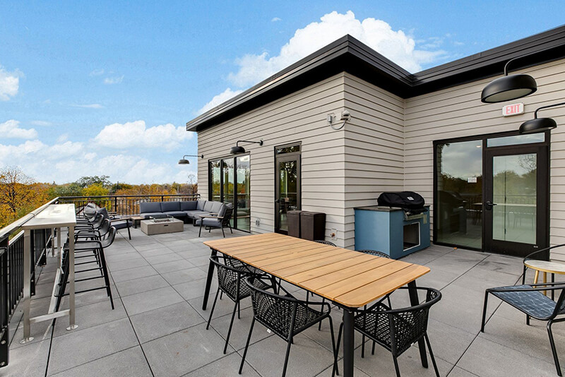 the community balcony with seating and a grill