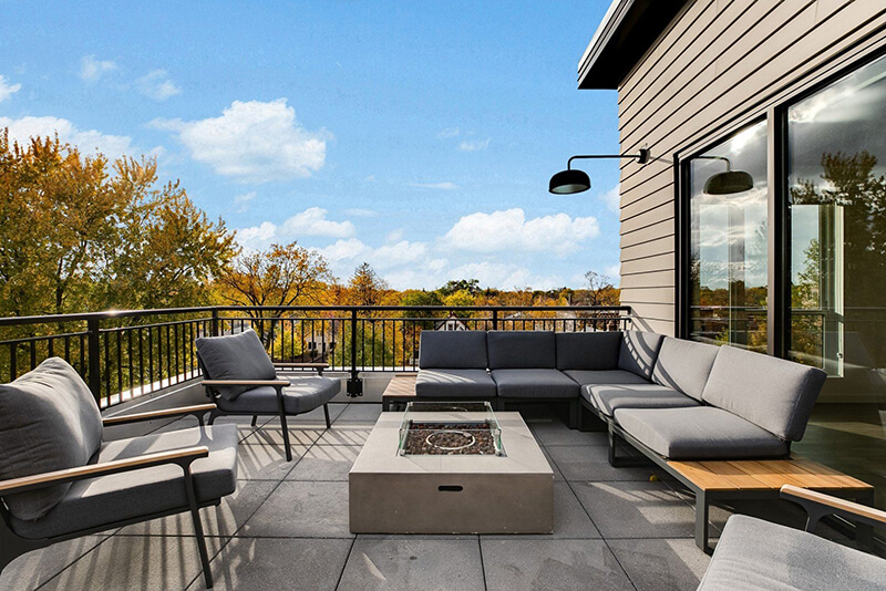 the community balcony with a firepit and a lot of seating