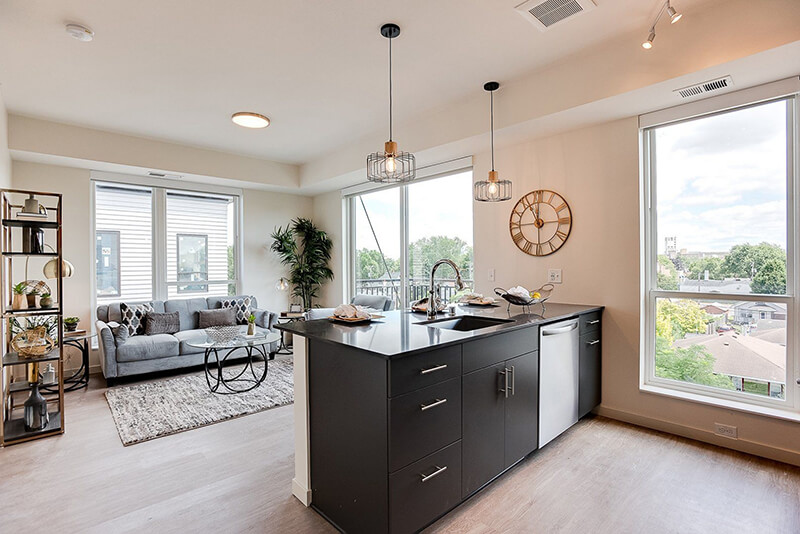 an apartment kitchen an living room