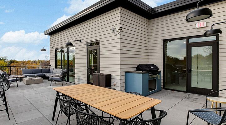 the community balcony with plenty of seating and a grill for everyone to use.