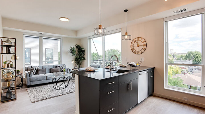 an apartment kitchen counter and living room